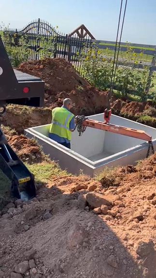 Underground storm shelter installation in Lubbock, TX — worker placement
